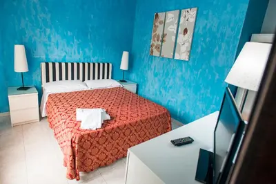 Letto o letti in una camera di Sant'Antonio Garden Rooms Apartments