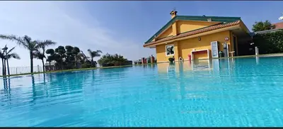 Piscina di Bright apartment in Acireale, 60 sqm with shared pool o nelle vicinanze