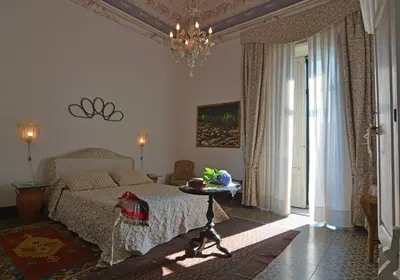 Letto o letti in una camera di Palazzo Nicotra Dimora Storica