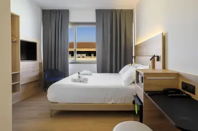 Letto o letti in una camera di B&B HOTEL Catania City Center