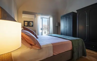 Letto o letti in una camera di Mirone - Suite Apartments Catania Centro