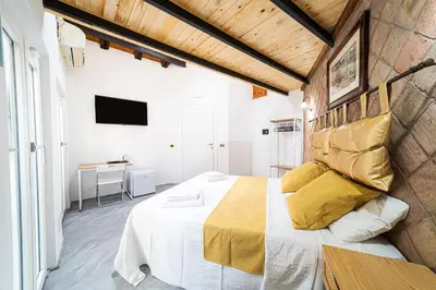 Letto o letti in una camera di VOLCANO'S SUITE - MANDORLO - The First Eco - Chic Suite in Sicily