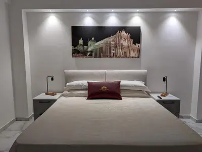 Letto o letti in una camera di Infinity House Catania