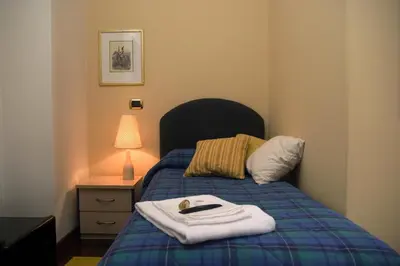 Letto o letti in una camera di La Cittadella Residence Città Universitaria Policlinico Catania