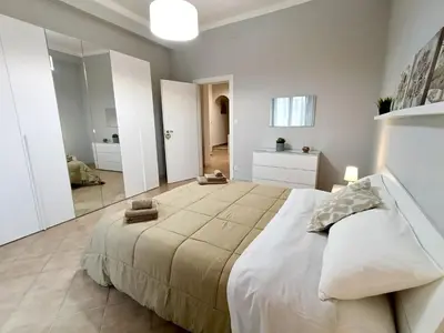 Letto o letti in una camera di Alis Living Apartment - Quadrilocale ampio a Catania