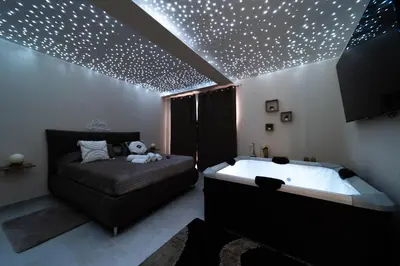 Letto o letti in una camera di Desiree Luxury House- vasca idromassaggio