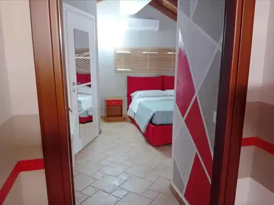 Letto o letti in una camera di Casa Happy - La mansarda del sorriso con parcheggio privato a Valcorrente