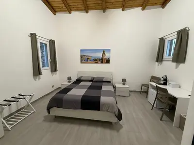 Letto o letti in una camera di DM Rooms