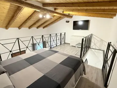 Letto o letti in una camera di DM Rooms