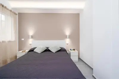 Letto o letti in una camera di GiuMar Apartments Acitrezza