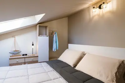 Letto o letti in una camera di Il Nido Vista Mare - Mansarda panoramica