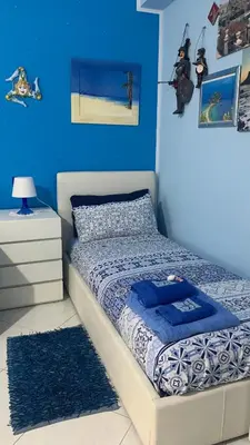 Letto o letti in una camera di Casa Limoni al mare tra Catania Etna e Taormina