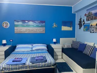 Letto o letti in una camera di Casa Limoni al mare tra Catania Etna e Taormina