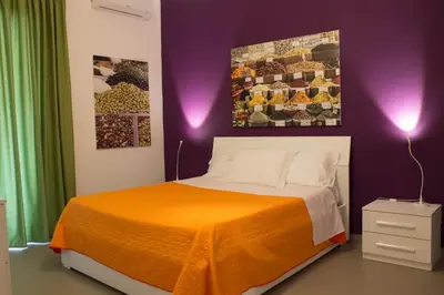 Letto o letti in una camera di Residence Palazzo dei Delfini by RECEPTIO