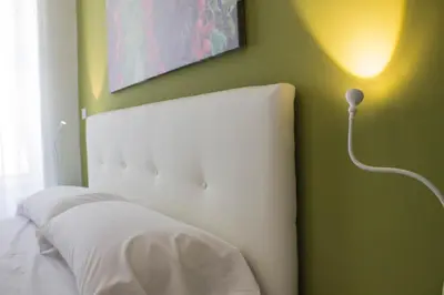 Letto o letti in una camera di Residence Palazzo dei Delfini by RECEPTIO