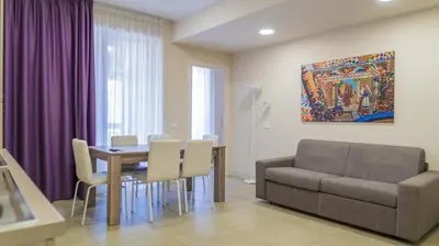 Area soggiorno di Residence Palazzo dei Delfini by RECEPTIO