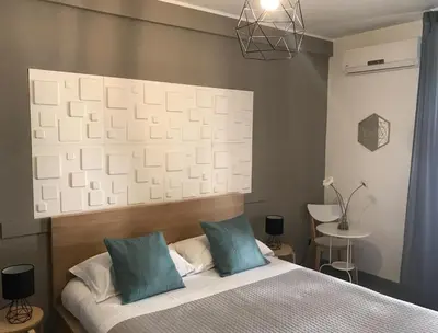 Letto o letti in una camera di Stesicoro InHabit