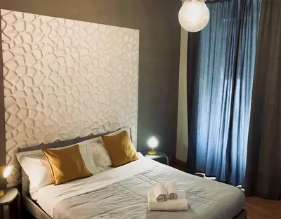 Letto o letti in una camera di Stesicoro InHabit