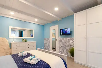 Letto o letti in una camera di Casa della Perla, Parcheggio disponibile, centrale