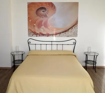 Letto o letti in una camera di B&B Stella Marina