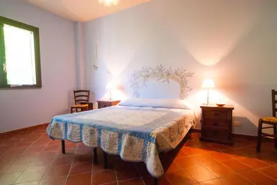 Letto o letti in una camera di B&B La Rena Rossa