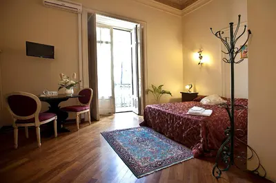 Letto o letti in una camera di B&B Alba