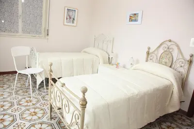 Letto o letti in una camera di CASA VACANZE FRANCESCO E TANINA