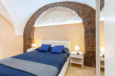 Letto o letti in una camera di GuestHost - Cerami Studio Flat