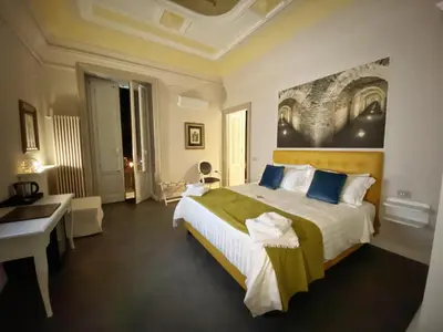 Letto o letti in una camera di ANFITEATRO LE SUITES