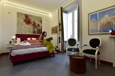 Letto o letti in una camera di ANFITEATRO LE SUITES