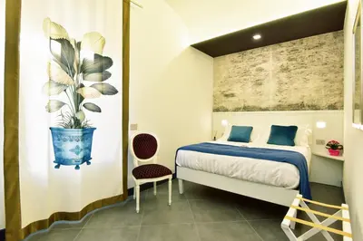 Letto o letti in una camera di ANFITEATRO LE SUITES