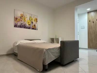 Letto o letti in una camera di La pigna delle Aci Apartment
