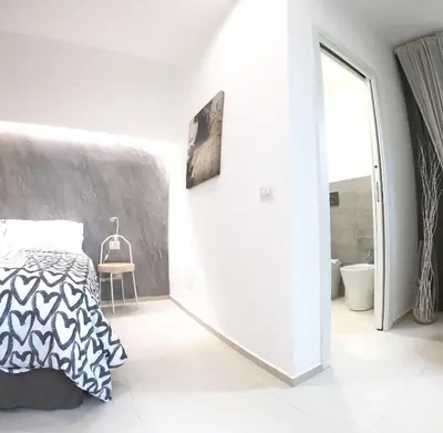 Letto o letti in una camera di Home Catania Dante Accommodations