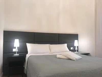 Letto o letti in una camera di Motta Palace Apartments & Rooms
