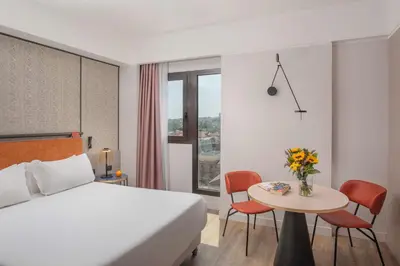 Letto o letti in una camera di NH Catania Centro