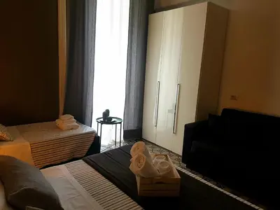 Letto o letti in una camera di Ottomood Ala Ovest Catania Centro
