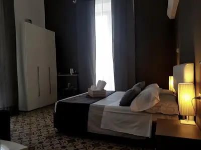 Letto o letti in una camera di Ottomood Ala Ovest Catania Centro