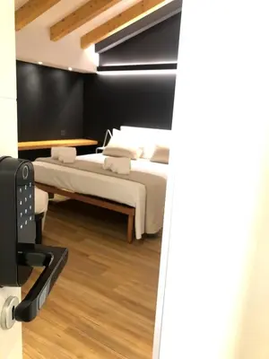 Letto o letti in una camera di Ottomood House Catania