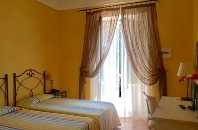 Letto o letti in una camera di Etna Hotel