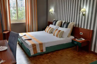 Letto o letti in una camera di Grande Albergo Maugeri
