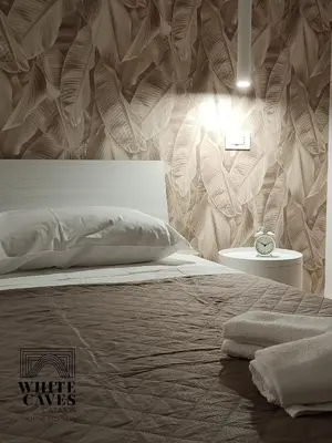 Letto o letti in una camera di white caves catania home holiday