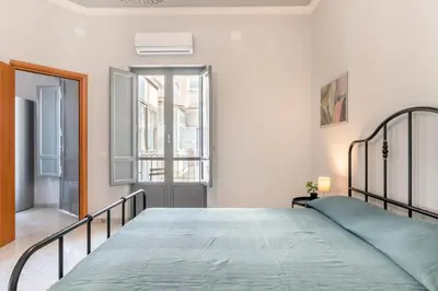 Letto o letti in una camera di GuestHost - Parco Falcone Borsellino Cozy Apartment