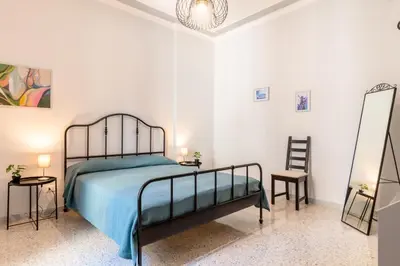 Letto o letti in una camera di GuestHost - Parco Falcone Borsellino Cozy Apartment