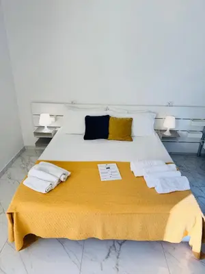 Letto o letti in una camera di ROOMS alCentro