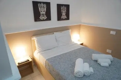 Letto o letti in una camera di Sicily House Caronda Catania